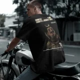 A man on Bike wearing A t-shirt of lord mahadev Shiva